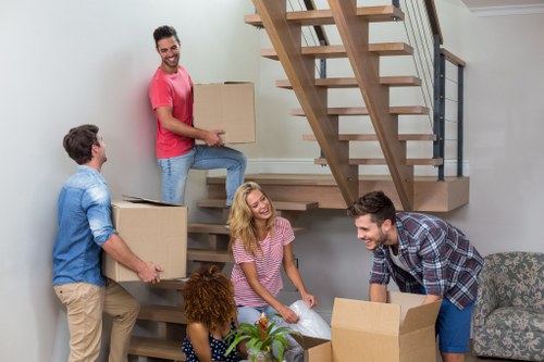 Packed moving boxes and furniture being loaded into a van