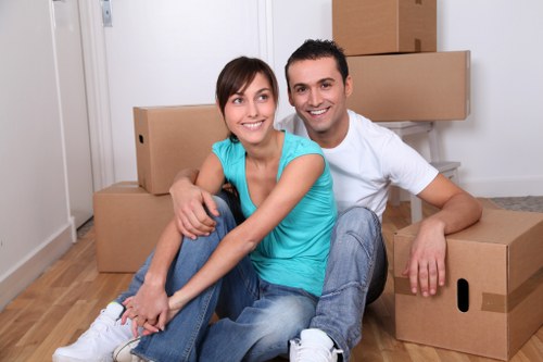 Moving team transporting office equipment through a Finchley building